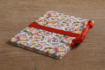 Small photo album with colorful Florentine paper and a red bow